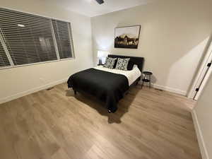 Bedroom with ceiling fan and light hardwood / wood-style floors