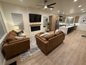 Living room featuring ceiling fan and light hardwood / wood-style floors