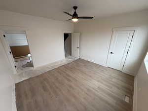 Unfurnished bedroom with light hardwood / wood-style floors and ceiling fan