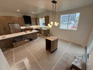 Kitchen with a kitchen island, decorative backsplash, hanging light fixtures, range hood, and light tile patterned floors