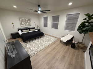 Bedroom featuring hardwood / wood-style flooring and ceiling fan