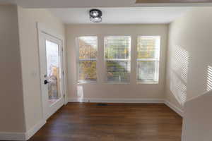 Interior space featuring dark wood-type flooring