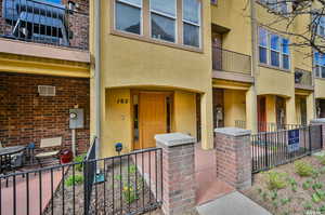 View of exterior entry featuring a balcony and a patio area