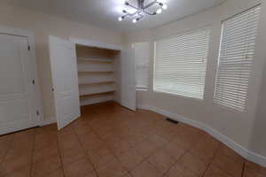 chandelier and light tile patterned floors