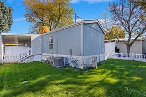 Exterior space featuring a yard and central AC unit