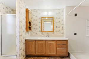 Bathroom with vanity and a shower with shower door