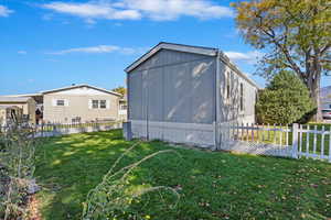 View of property exterior with a yard