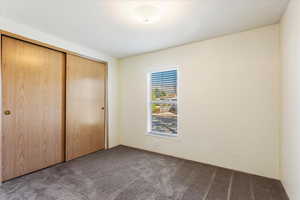 Unfurnished bedroom with a closet and carpet