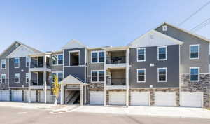 Multi unit property with a balcony and a garage