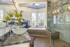 Bathroom with vanity, tile patterned floors, and separate shower and tub