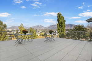 View of patio / terrace with a mountain view and a balcony