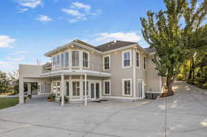 Back of house with a patio, french doors, and a balcony