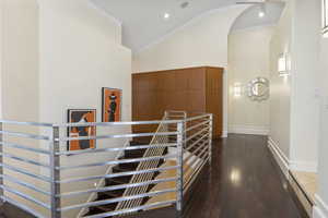 Hall featuring crown molding, high vaulted ceiling, and dark hardwood / wood-style flooring