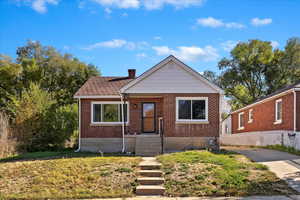 Bungalow-style home with a front yard