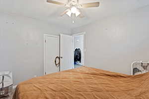 Carpeted bedroom featuring ceiling fan