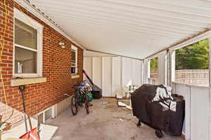 View of patio with a grill