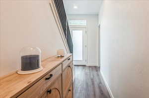 Corridor with dark hardwood / wood-style flooring