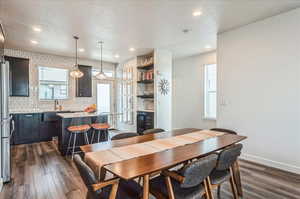 Dining space featuring dark wood-type flooring and sink