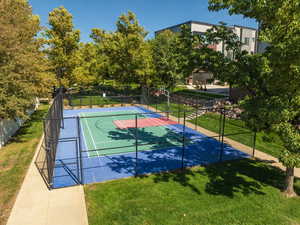 View of basketball court featuring a lawn