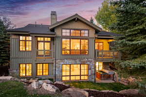 Back house at dusk with a balcony