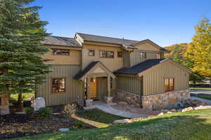 View of front of property with a front lawn and central AC unit