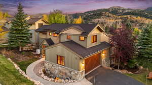 View of front of house featuring a mountain view and a garage