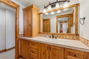 Bathroom with vanity and backsplash