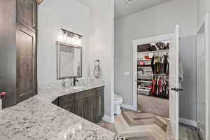 Bathroom featuring vanity, toilet, and tile flooring