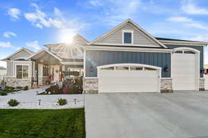 Craftsman house with a garage and a front lawn