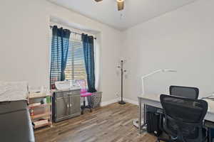 Office space with ceiling fan and hardwood / wood-style floors