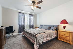 Carpeted bedroom with ceiling fan