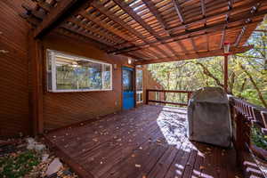 Deck featuring area for grilling and a pergola