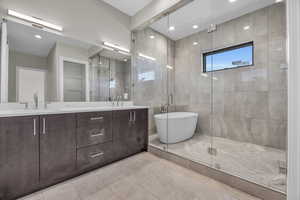 Master Bathroom with vanity, independent shower and bath, tile patterned floors, and tile walls