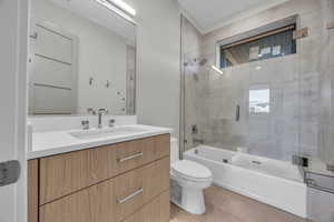 Full bathroom with toilet, bath / shower combo with glass door, vanity, and tile patterned flooring