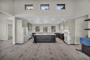 Kitchen featuring a center island, sink, backsplash, and gray cabinetry