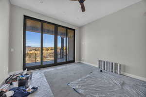 Master bedroom featuring ceiling fan, carpet floors, and access to exterior deck