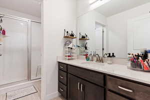 Bathroom with vanity, hardwood / wood-style floors, and an enclosed shower