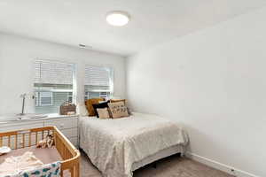 Bedroom featuring light colored carpet