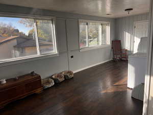 Interior space with washer / clothes dryer and dark wood-type flooring