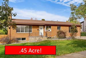 Ranch-style house with a front lawn