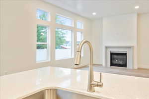 Room details with sink and light stone counters