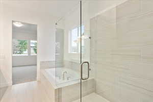 Bathroom featuring shower with separate bathtub