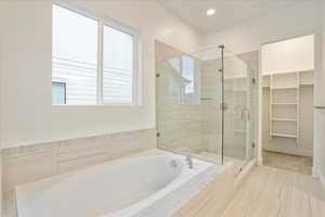 Bathroom featuring plus walk in shower and tile patterned flooring