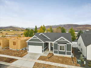 View of front of property featuring a garage and a mountain view