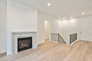 Unfurnished living room featuring light wood-type flooring