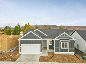 View of front of property featuring a garage and a mountain view