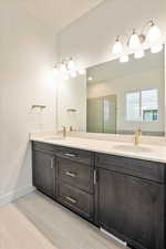 Bathroom featuring vanity and an enclosed shower