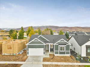 View of front of house with a garage and a mountain view