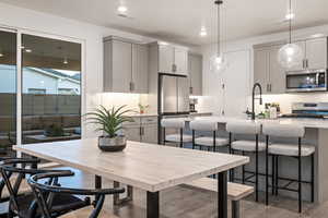 Dining space featuring sink and dark hardwood / wood-style flooring