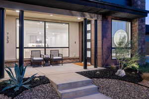 Doorway to property featuring a patio area